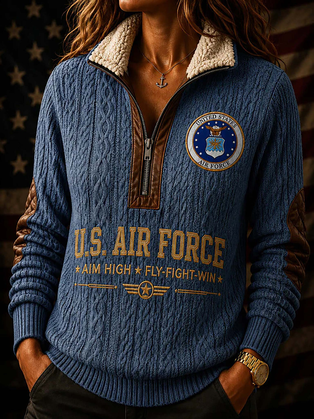 A blue cable-knit quarter-zip sweater shown from both front and back, with a cream sherpa collar, brown elbow patches, and U.S.