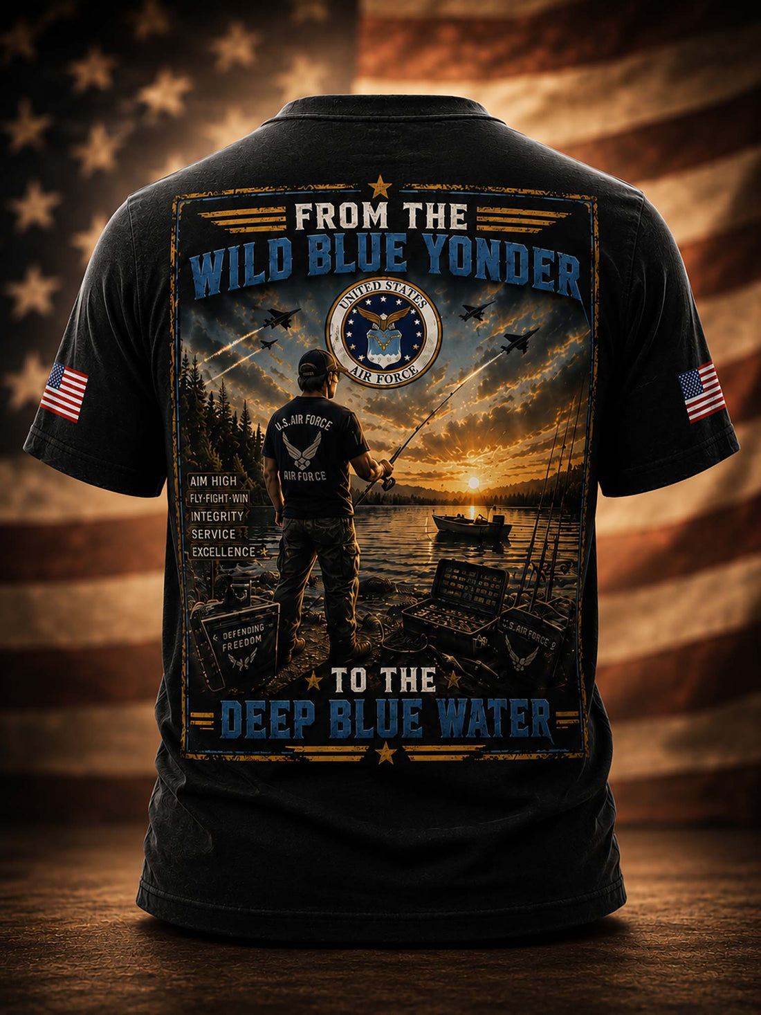 A black short-sleeve t-shirt shown from the back, featuring a large military-themed graphic print with a fisherman, boats on the water, a sunset, and the text 'FROM THE WILD BLUE YONDER TO THE DEEP BLUE WATER.' The shirt is displayed against a blurred American flag and wooden surface background.
