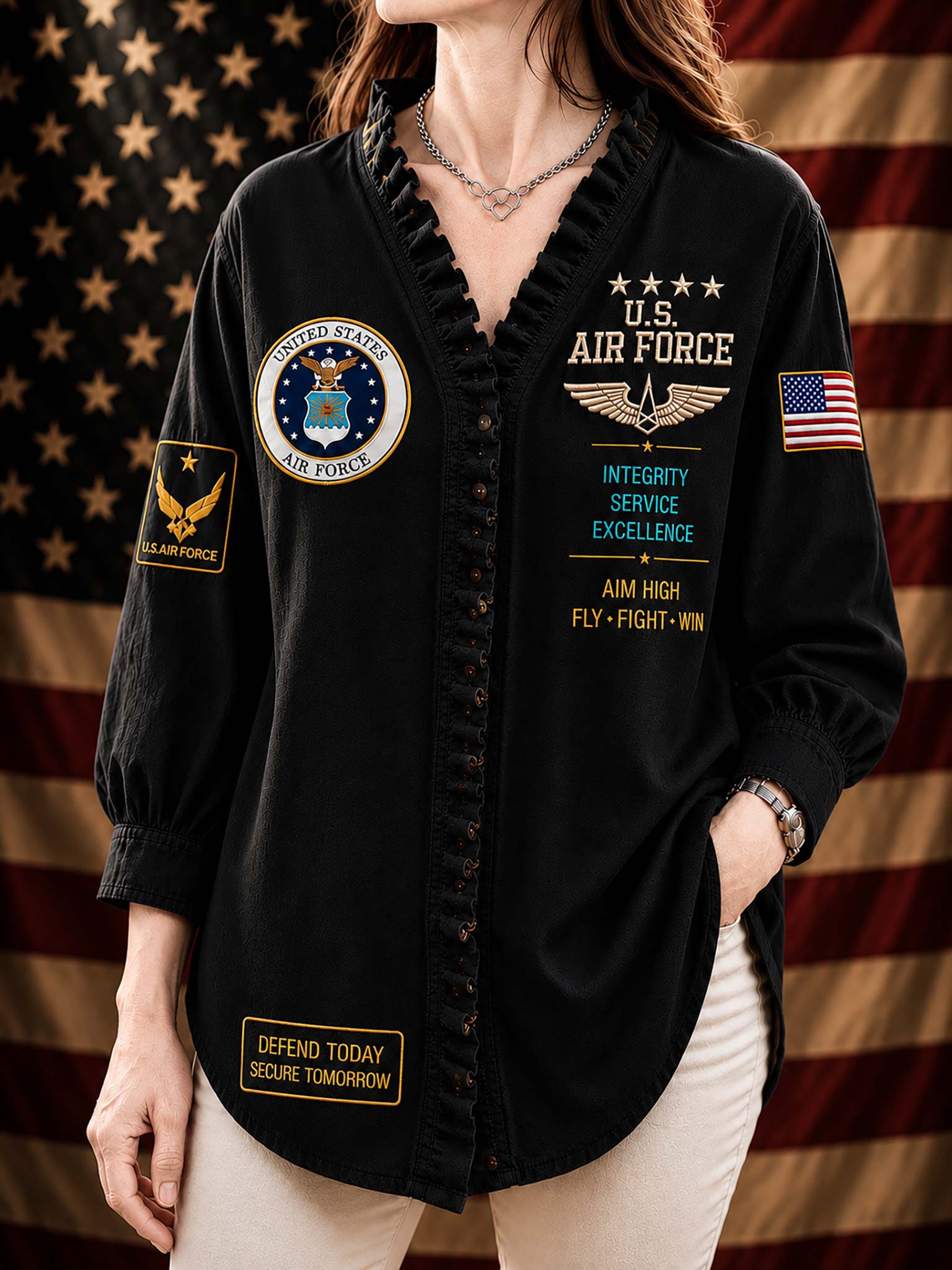 A woman wearing a black long-sleeve button-front shirt with ruffled trim, military-inspired patches, and U.S.