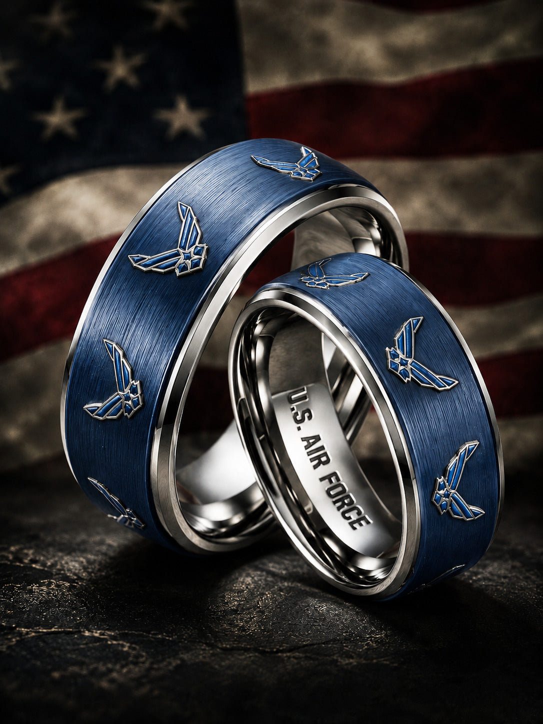 Two silver wedding bands with brushed blue inlays featuring U.S.