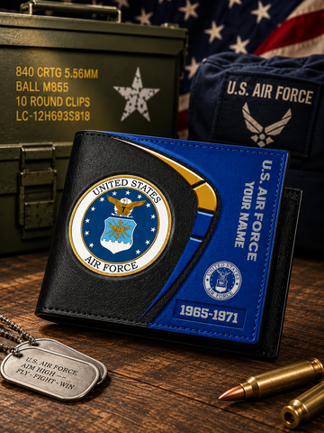A black and blue leather United States Air Force themed wallet displayed on a wooden surface with military-themed props including a green military case, an American flag, a navy U.S.
