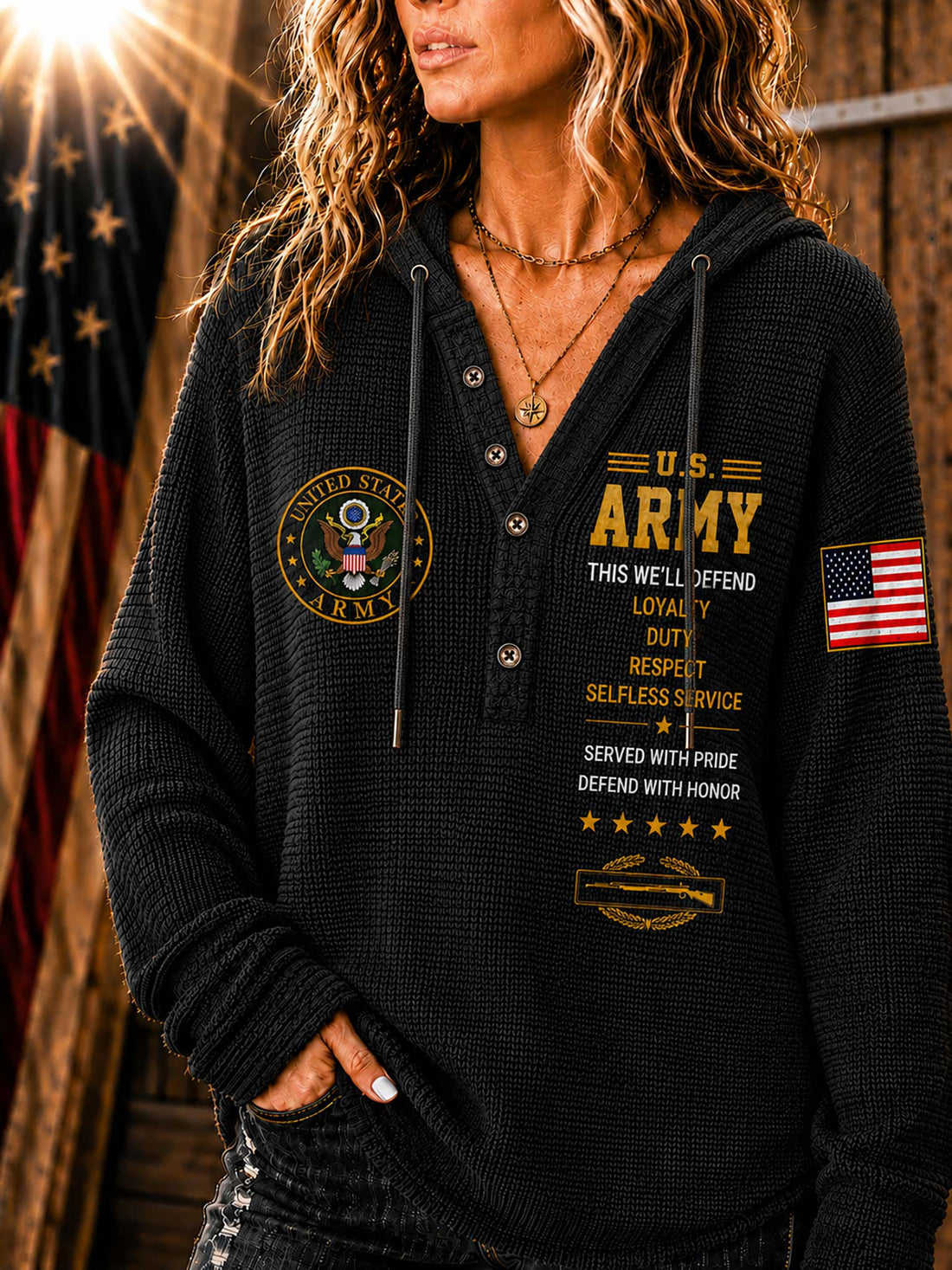 A woman wearing a light beige waffle-knit hoodie sweatshirt with military-themed graphics, including 'U.S.