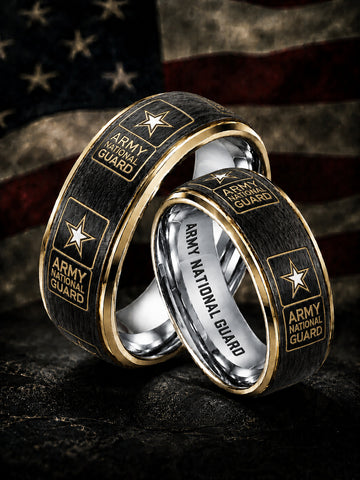 Two interlocking wedding bands with a black wood grain exterior, gold trim, and 'ARMY NATIONAL GUARD' text with a star logo, set against a blurred American flag background.