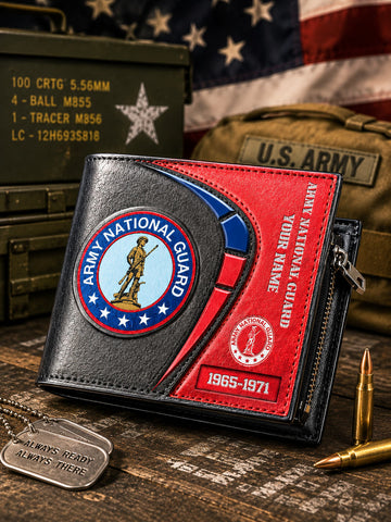 A black and red bifold wallet with Army National Guard patches, displayed on a rustic wooden surface with military-themed props including an American flag, a U.S.