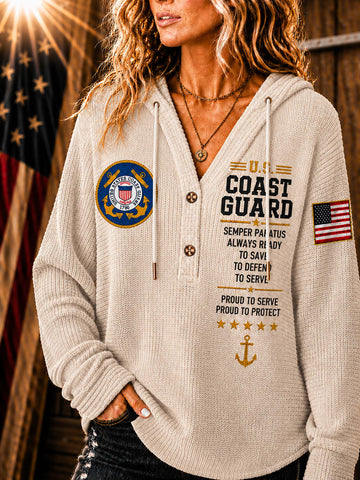 A woman wearing a beige waffle-knit hoodie with U.S.