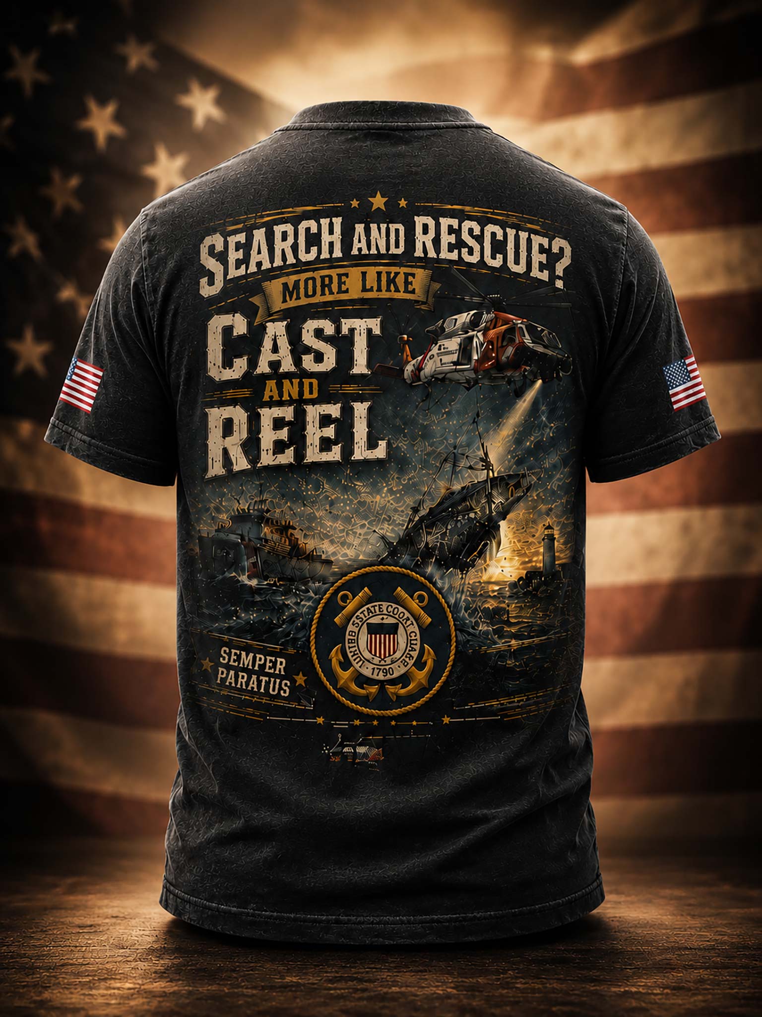 A black short-sleeve t-shirt shown from the back, featuring a large military-themed graphic with the words 'SEARCH AND RESCUE? MORE LIKE CAST AND REEL' and a helicopter over a ship at sea. The shirt is displayed against a blurred American flag background on a wooden surface.