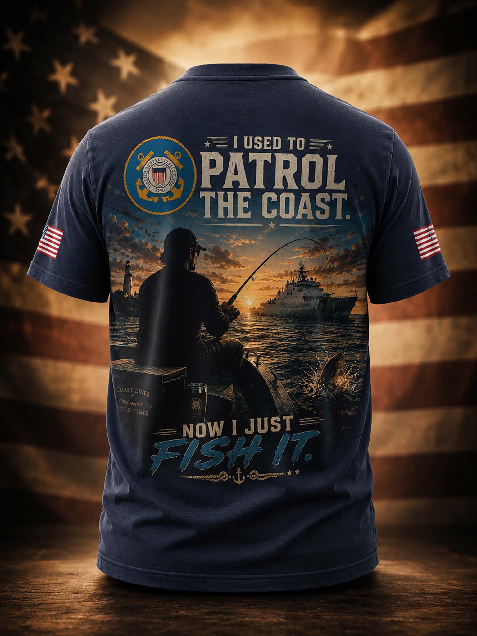 A navy blue short-sleeve t-shirt shown from the back, featuring a large graphic print with a fisherman silhouette, a patrol boat, and the text 'I USED TO PATROL THE COAST. NOW I JUST FISH IT.