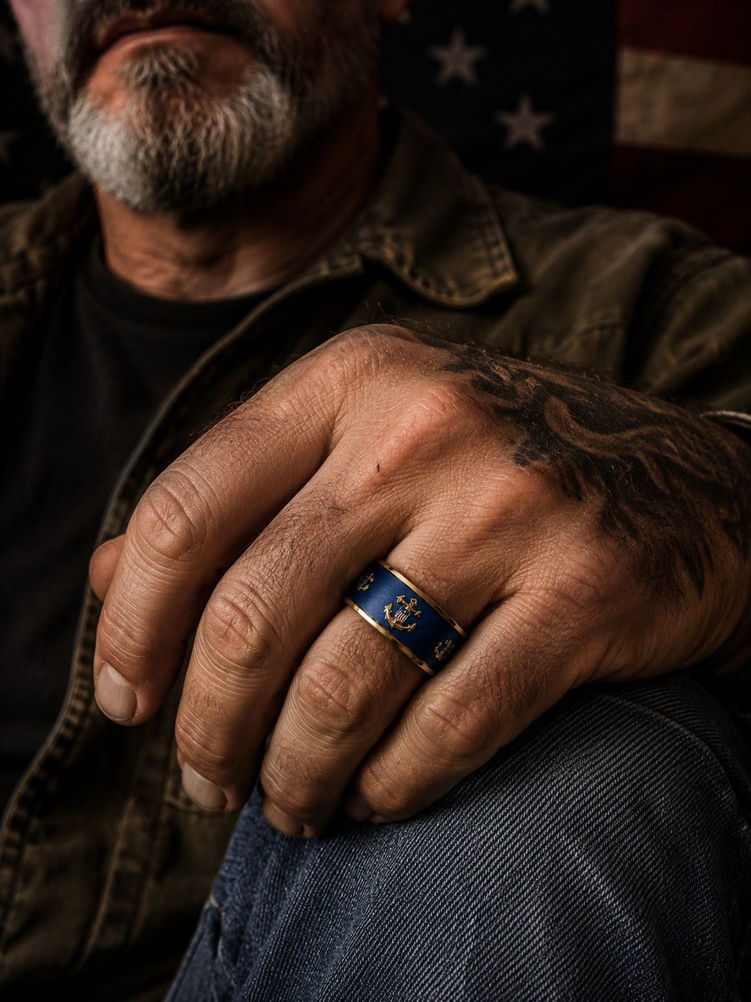 Two interlocking navy blue and gold Coast Guard rings with anchor details, displayed against a dark American flag background.