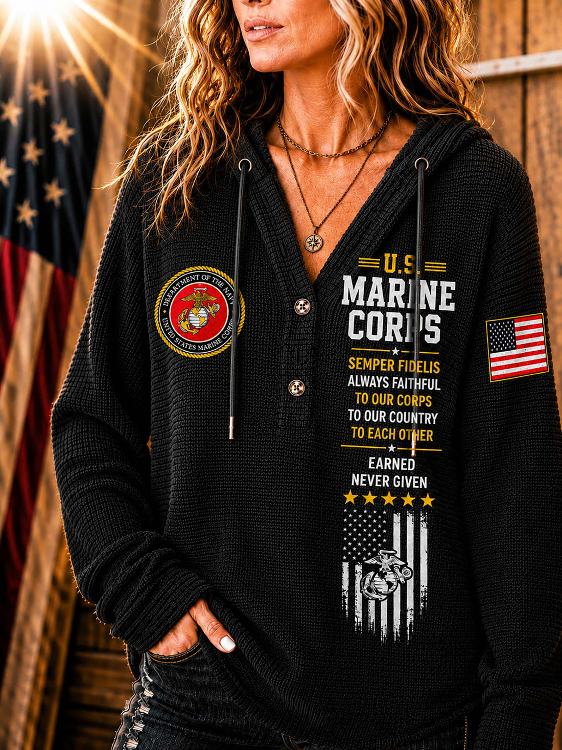 A woman wearing a beige waffle-knit hoodie with military-themed graphics, including a U.S.