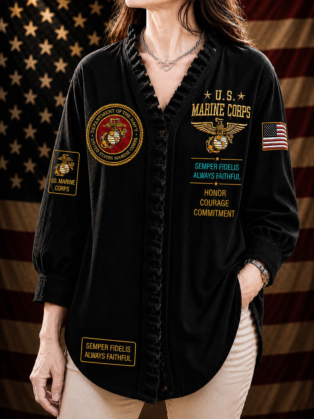 A woman wearing a black long-sleeve button-front shirt with military-themed patches and text, including U.S.