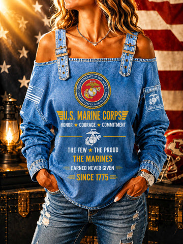 A woman wearing a blue denim off-the-shoulder top with a large U.S.