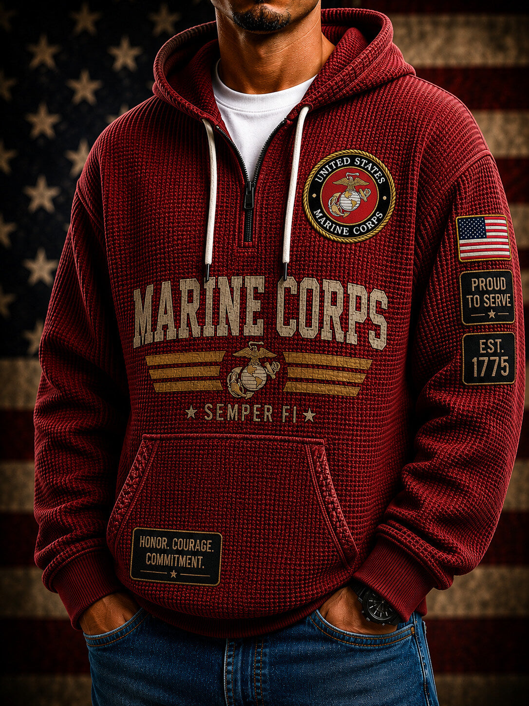 A maroon pullover hoodie shown from both front and back, featuring large Marine Corps text, the Marine Corps emblem, American flag patches, and black tactical-style graphics. The hoodie is displayed against a dark background with spotlight effects and a blurred American flag.