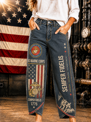 A person wearing dark blue distressed denim jeans with detailed U.S.
