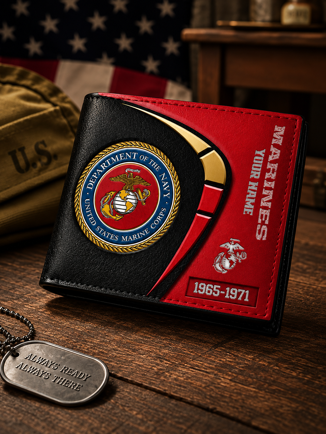 A black and red bi-fold wallet featuring the United States Marine Corps emblem, with 'MARINES' and 'YOUR NAME' printed on the front, displayed on a wooden surface next to a dog tag and a U.S.