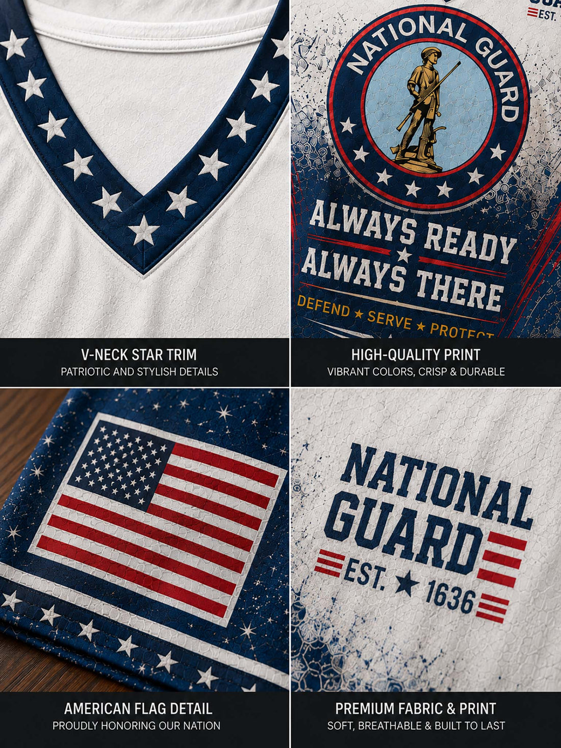 A woman wearing a distressed National Guard themed V-neck t-shirt with patriotic blue, white, and red graphics, paired with denim shorts, posed against a rustic wooden wall backdrop with themed props.