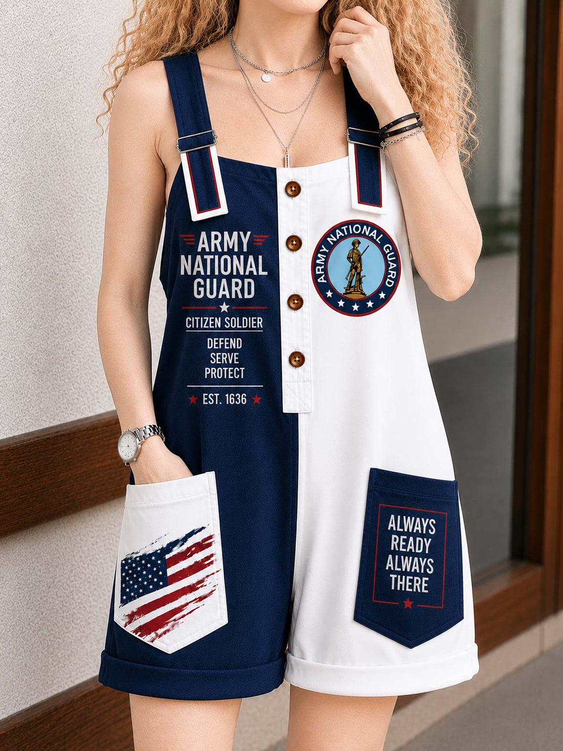 A woman wearing a sleeveless Army National Guard themed romper with navy blue and white panels, featuring patriotic and military-themed graphics on the front and pockets.