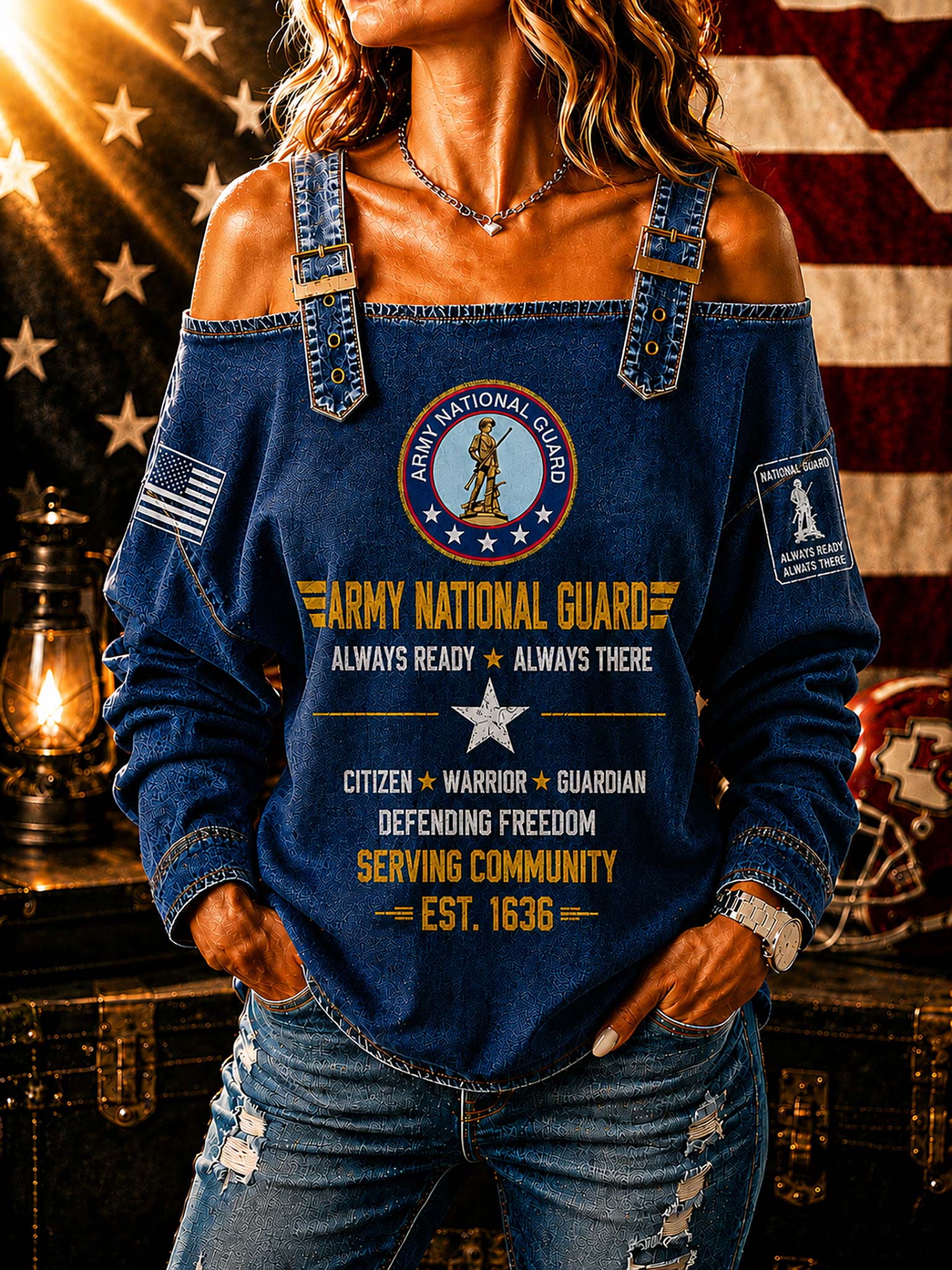 A woman wearing a blue off-the-shoulder long-sleeve top with Army National Guard graphics, including a central emblem and text, posed in front of an American flag and a vintage lantern.
