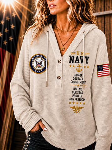 A woman wearing a ribbed knit beige hoodie with U.S.