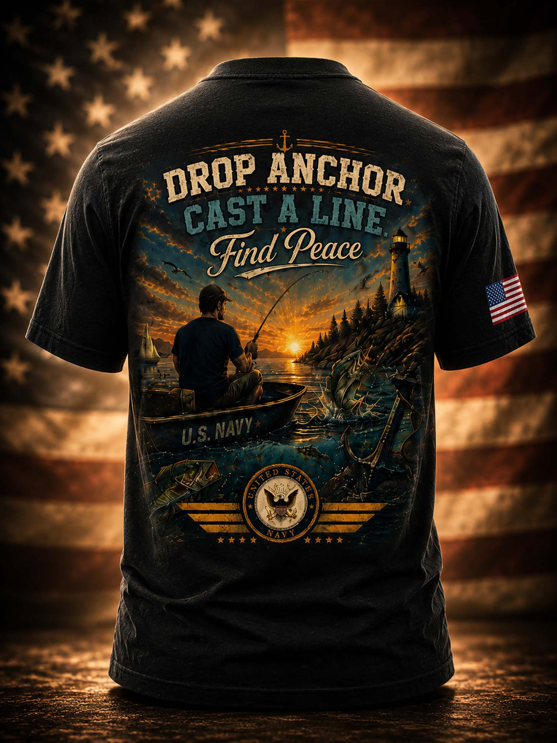 A black graphic t-shirt shown from the back, featuring a large patriotic fishing design with the text 'DROP ANCHOR CAST A LINE Find Peace' and 'U.S.