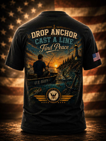 A black graphic t-shirt shown from the back, featuring a large patriotic fishing design with the text 'DROP ANCHOR CAST A LINE Find Peace' and 'U.S.