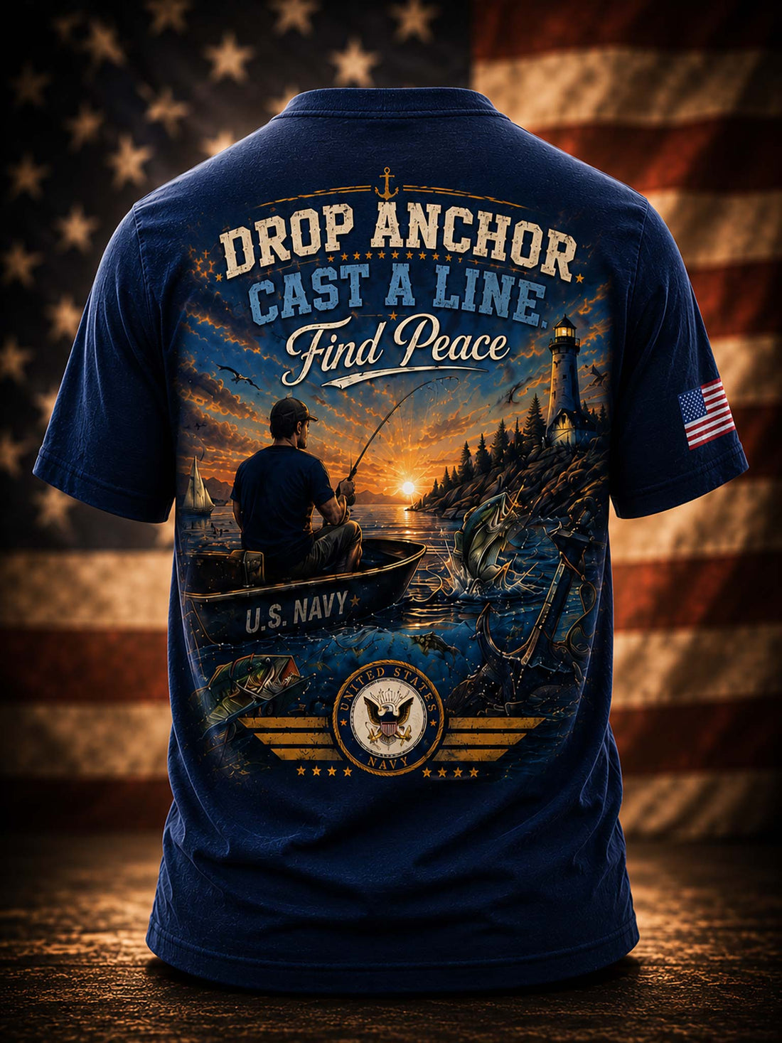 A black graphic t-shirt shown from the back, featuring a large patriotic fishing design with the text 'DROP ANCHOR CAST A LINE Find Peace' and 'U.S.