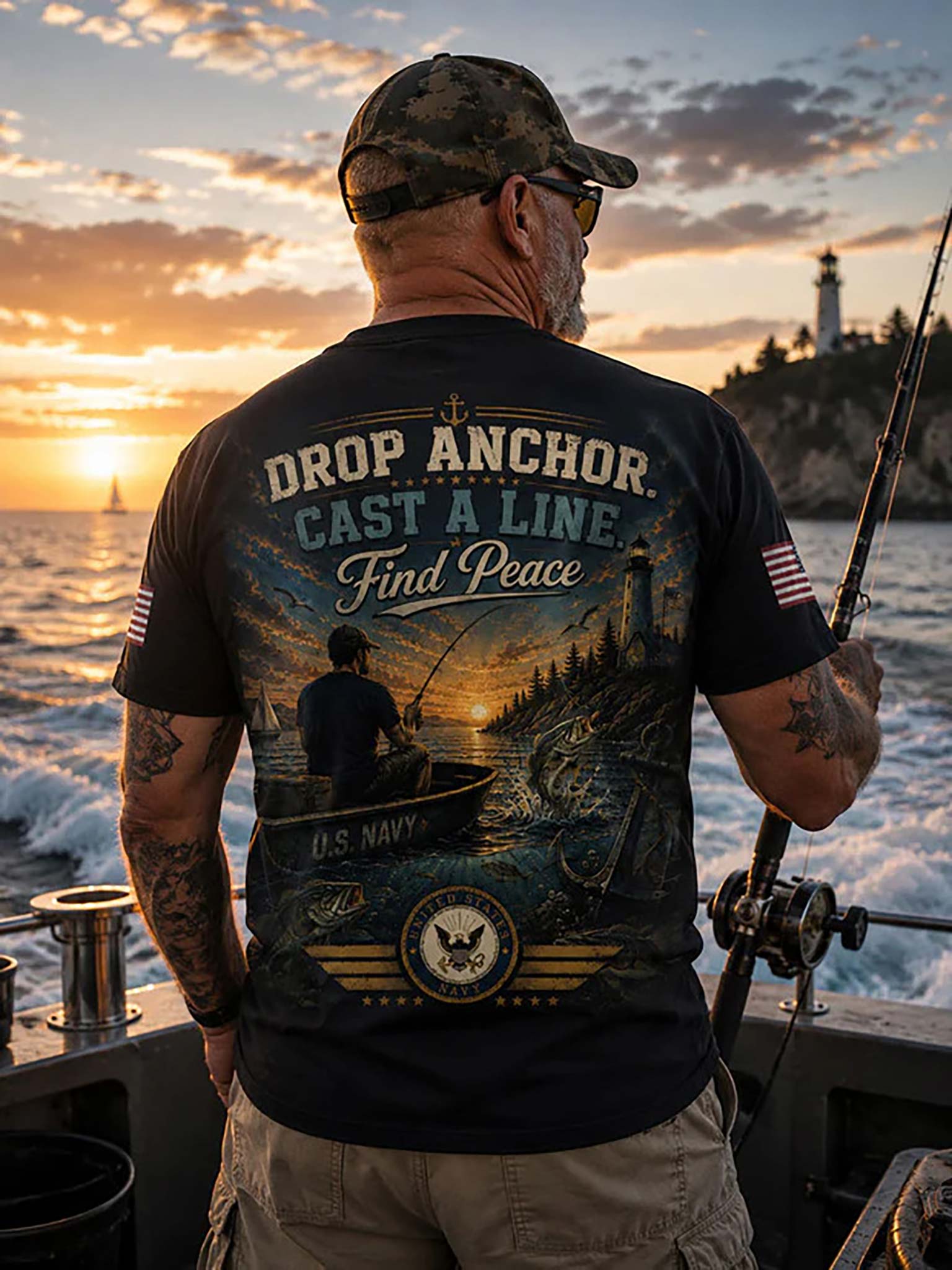 A man on a boat at sunset wearing a black graphic T-shirt with a large U.S.