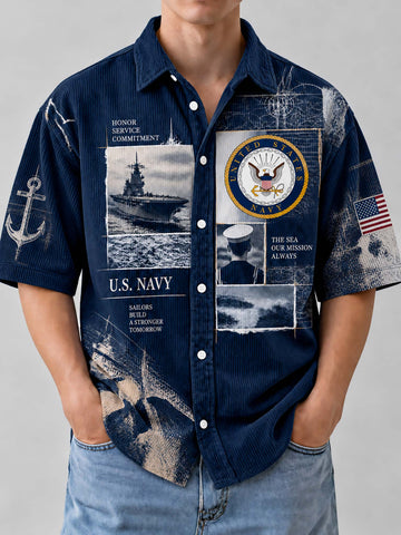 A man wearing a navy blue short-sleeve button-up shirt with a distressed U.S.