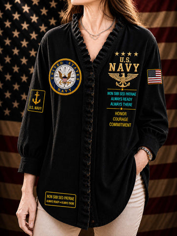 A woman wearing a black long-sleeve button-front shirt with U.S.