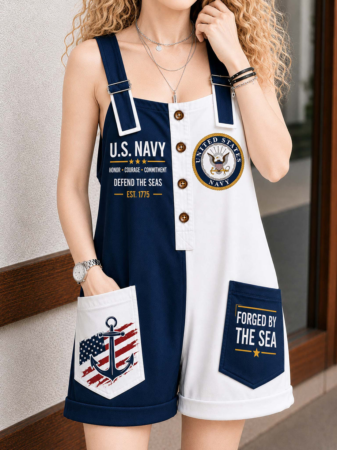 A woman wearing a navy and white split-front overall romper with U.S.