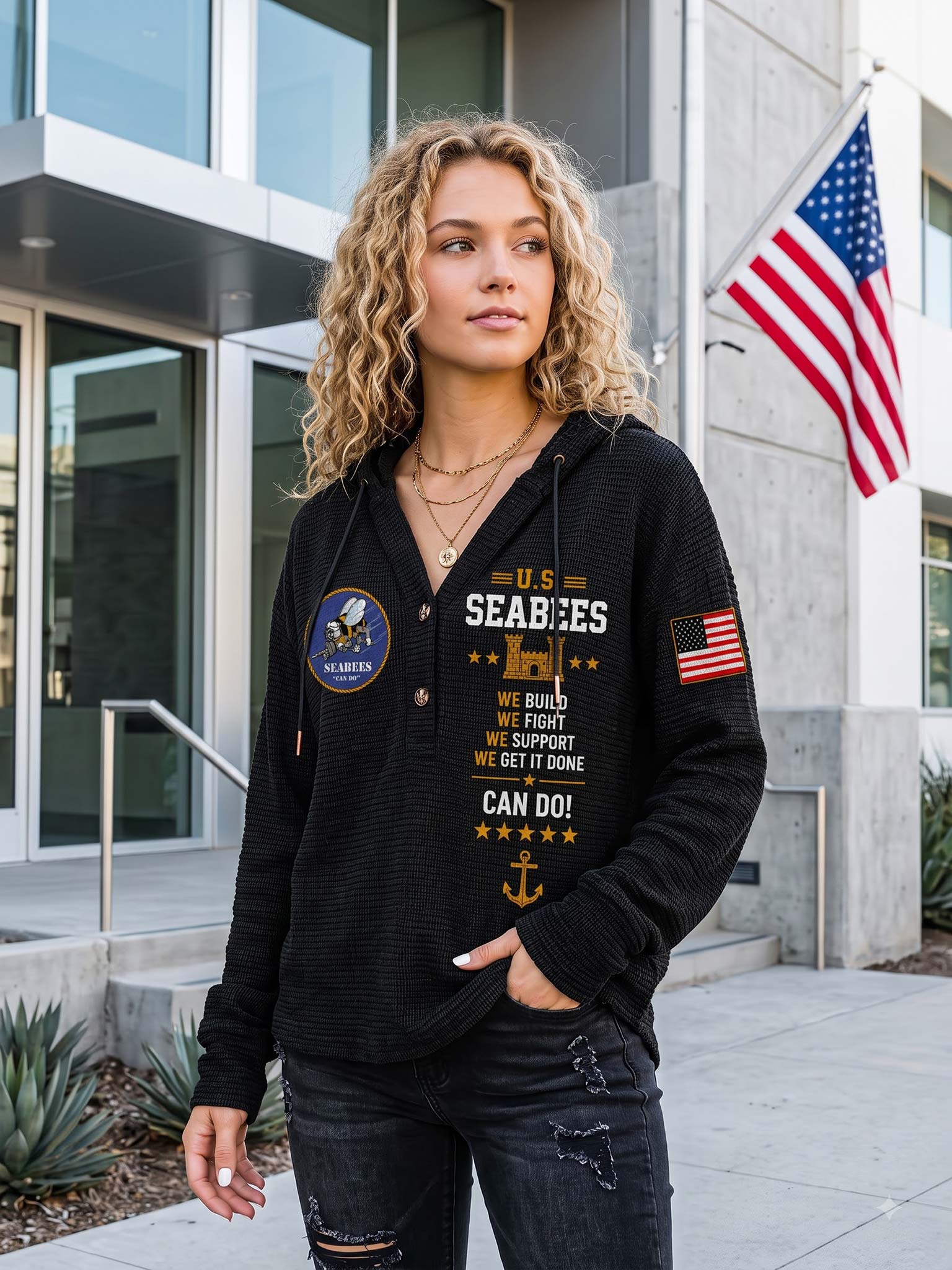 A woman wearing a black waffle-knit hoodie with a U.S.