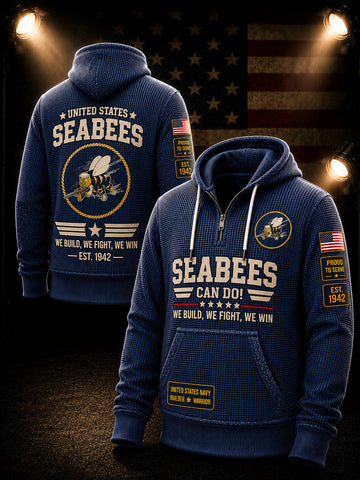 A navy blue waffle-knit pullover hoodie shown from both front and back, featuring large white and gold 'SEABEES' text, a Seabee emblem, American flag patches on the sleeves, and a gold 'United States Navy Honor & Honor' patch on the front pocket. The hoodie is displayed against a dark background with an American flag and spotlight effects.