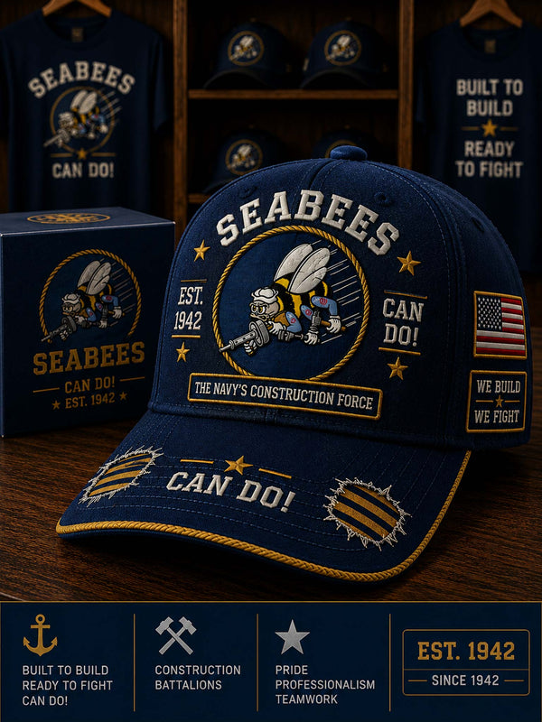 Blue Seabees cap with printed text and logos on a wooden surface.