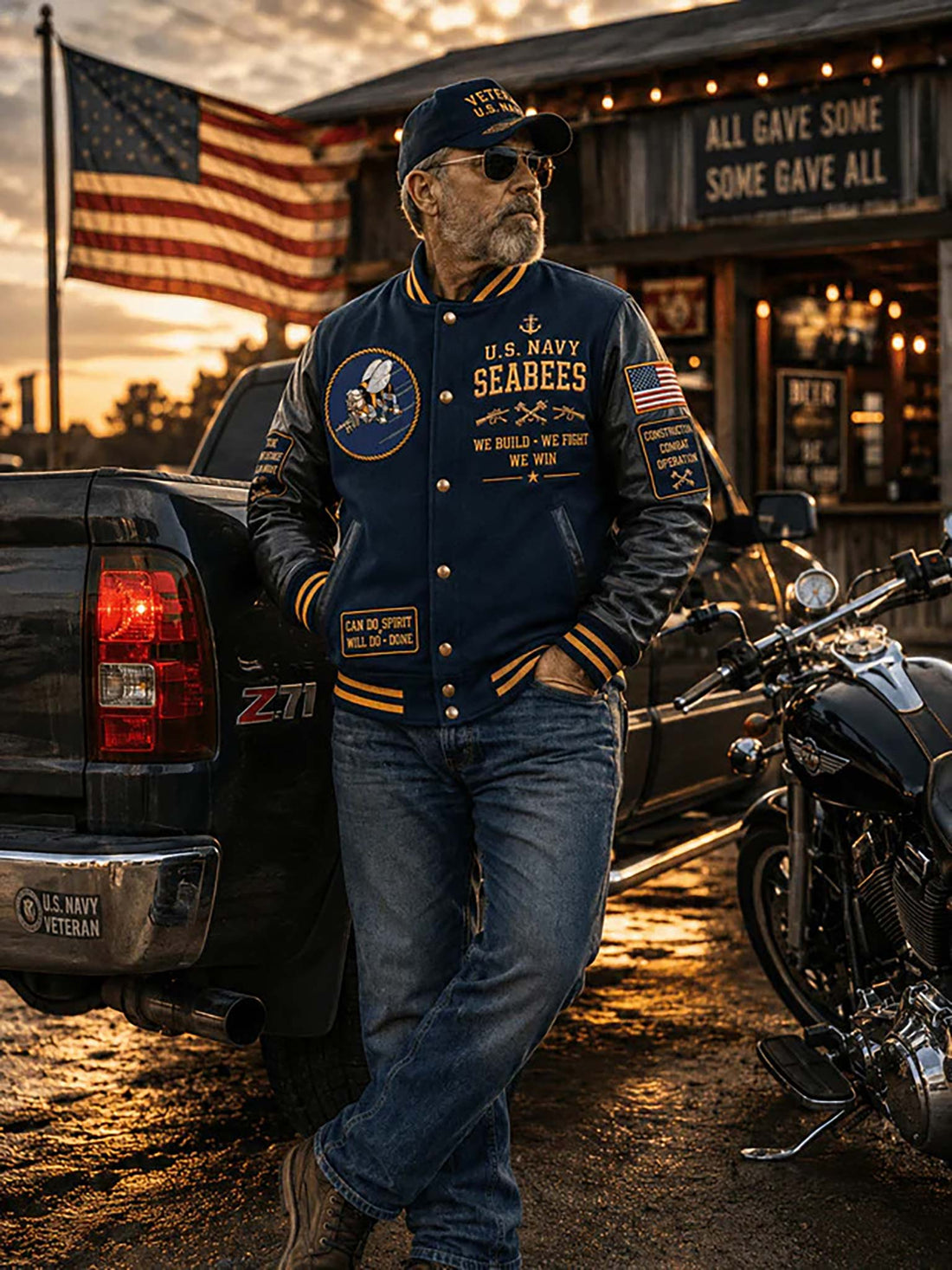 A navy blue and black varsity-style jacket with gold trim, shown from the front and back. The jacket features 'United States Navy Seabees' graphics, gold buttons, an American flag patch on the sleeve, and a circular 'Seabees Can Do!' emblem on the back.