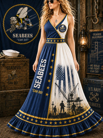 A woman models a sleeveless wrap-style maxi dress with a navy and white color scheme and gold accents, featuring U.S.