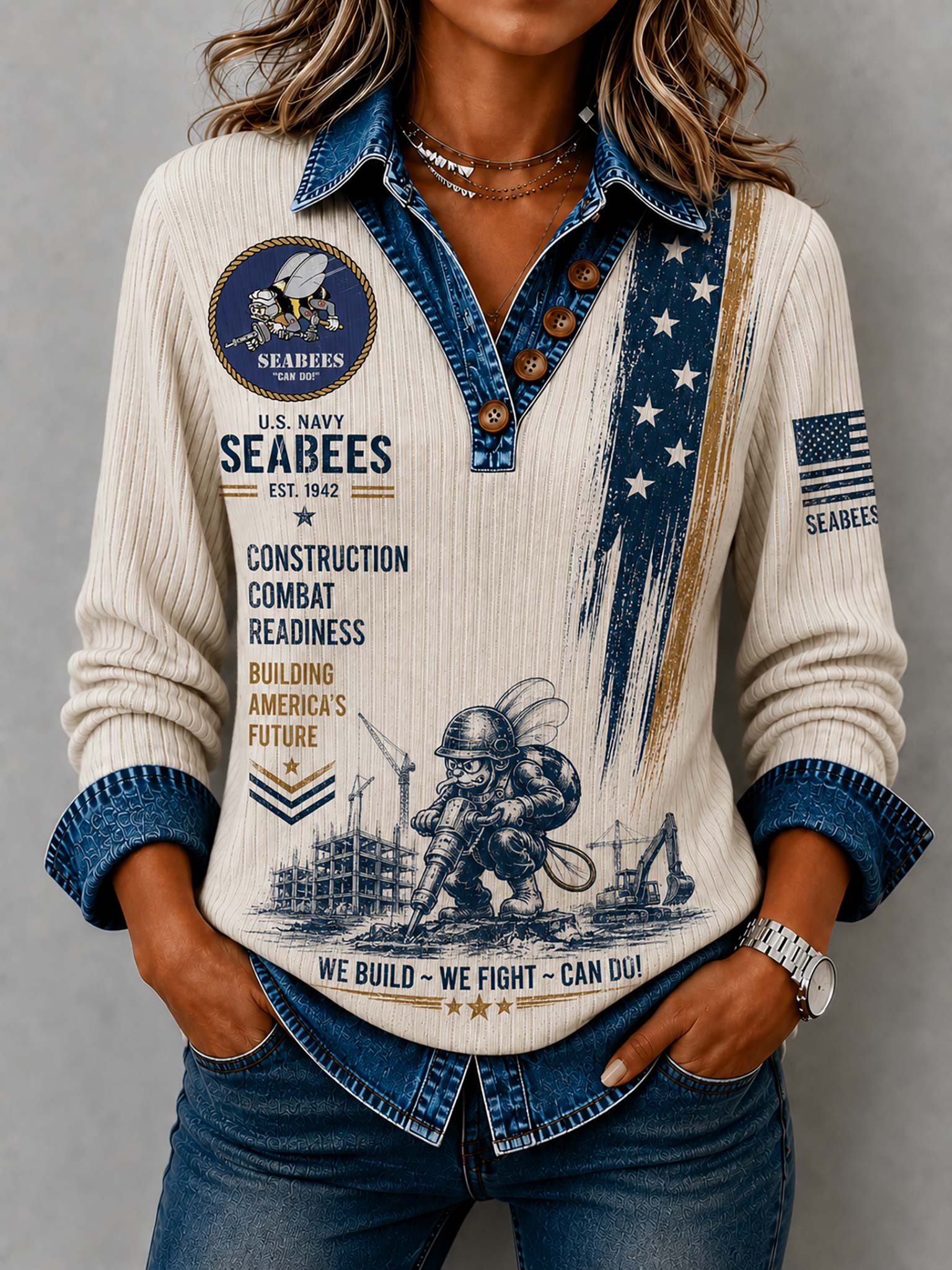 A woman wearing a cream ribbed long-sleeve shirt with a denim collar, buttons, cuffs, and a military-themed graphic print featuring 'U.S.