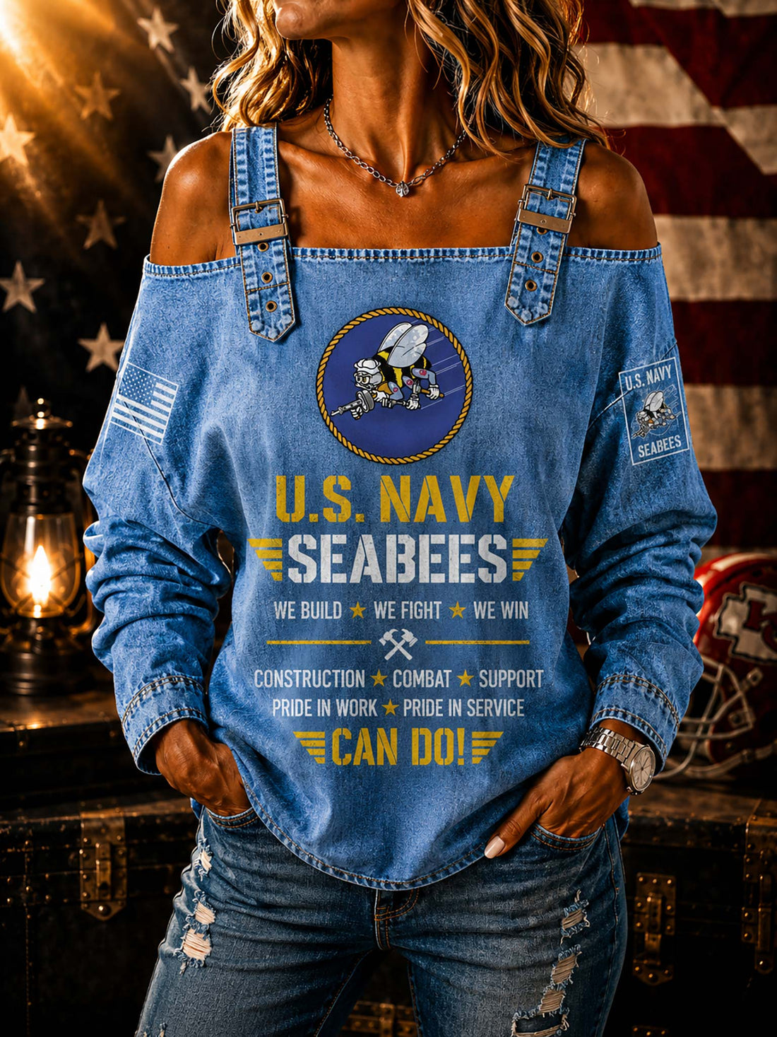 A woman wearing a blue off-the-shoulder long-sleeve top with a U.S.