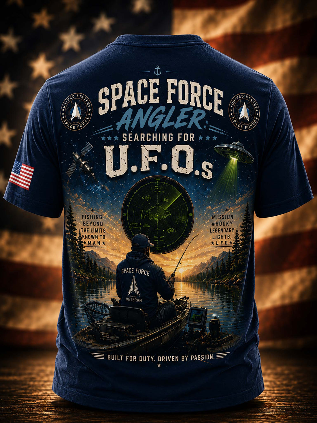 A black graphic t-shirt against a patriotic American flag and fishing scene background. 