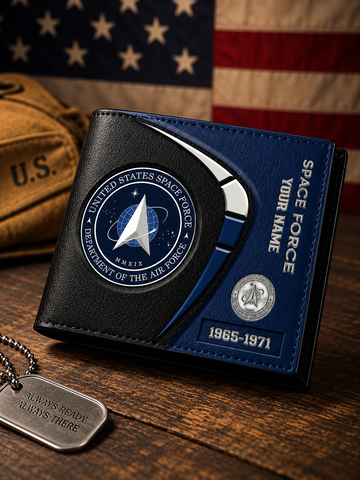 A personalized black and blue bi-fold wallet featuring the United States Space Force emblem, displayed on a wooden table with an American flag, a tan U.S.