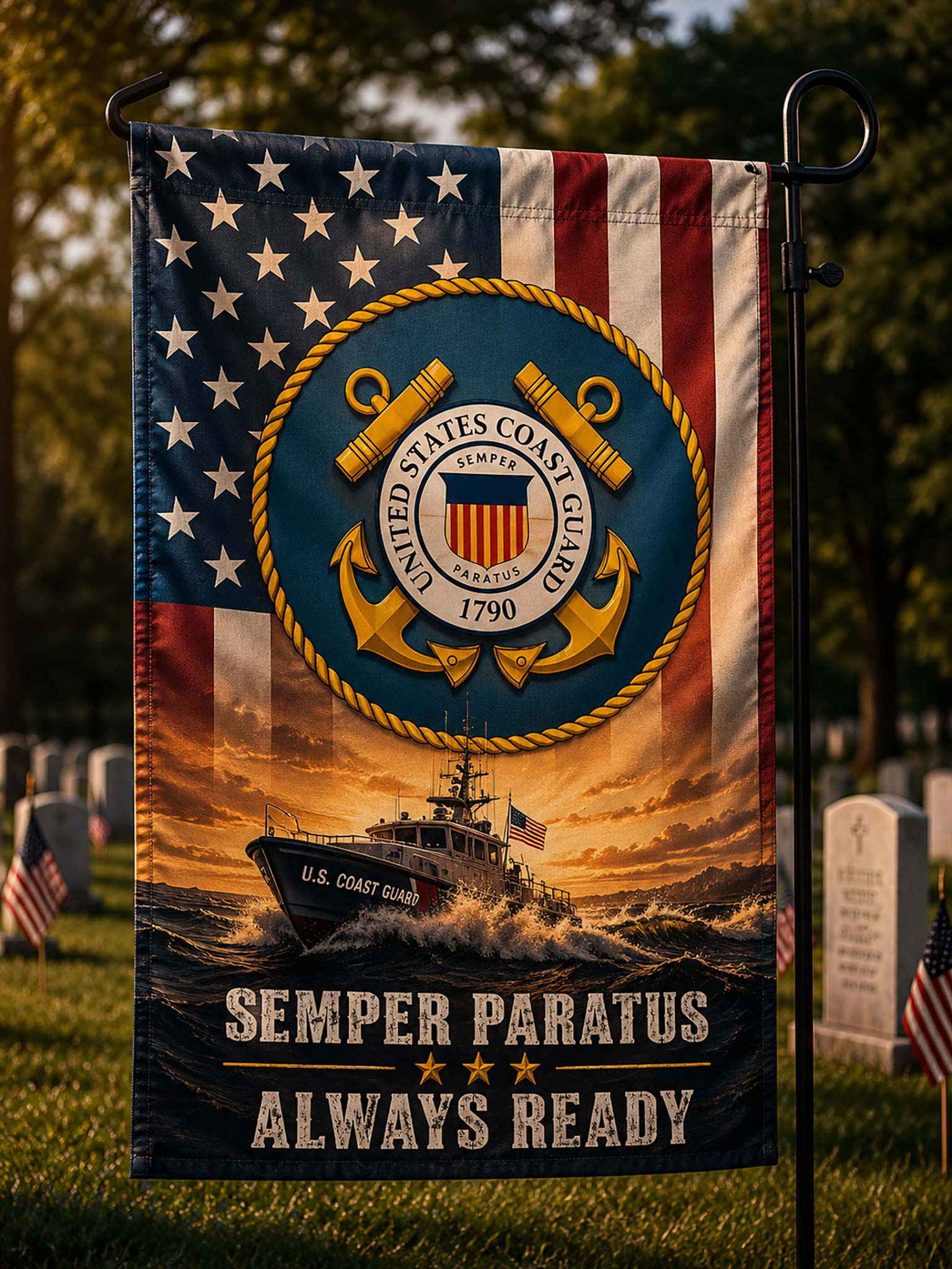A vertical garden flag mounted on a black metal pole outdoors in a grassy area. The flag features the United States Coast Guard emblem over an American flag background, with a U.