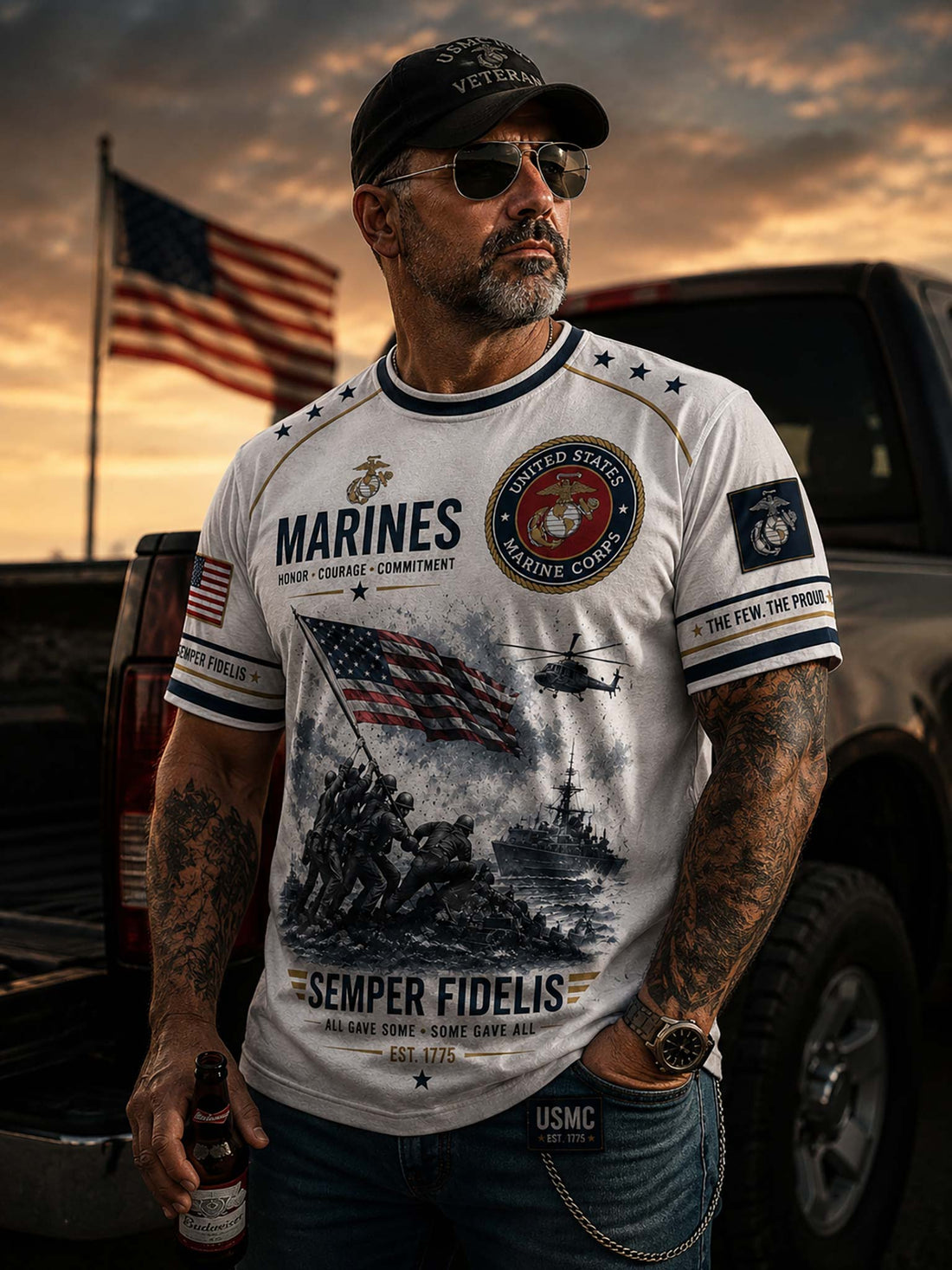 A white short-sleeve t-shirt with a detailed United States Marines graphic print. The design features the USMC emblem, the word 'MARINES', the Marine Corps seal, an American flag, a helicopter, soldiers raising the flag on Iwo Jima, a ship, and the motto 'SEMPER FIDELIS'.