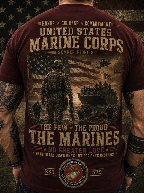 A man viewed from behind wearing a maroon t-shirt with a large United States Marine Corps graphic print on the back, featuring soldiers, an American flag, an amphibious landing craft, and military text.
