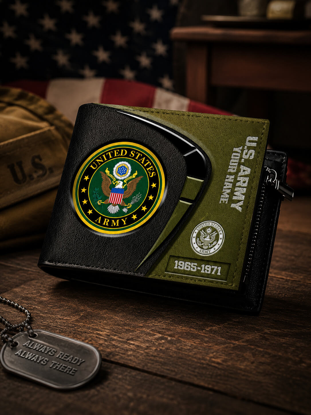 A black and olive green bifold wallet with United States Army emblems, displayed on a wooden surface with a dog tag and a blurred American flag in the background.
