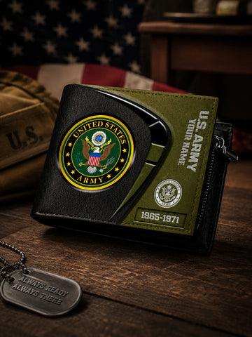 A black and olive green bifold wallet with United States Army emblems, displayed on a wooden surface with a dog tag and a blurred American flag in the background.
