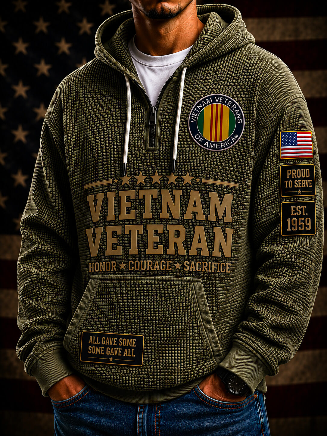 An olive green waffle-knit quarter-zip hoodie with 'VIETNAM VETERAN' printed on the front, worn by a man with a patriotic background.