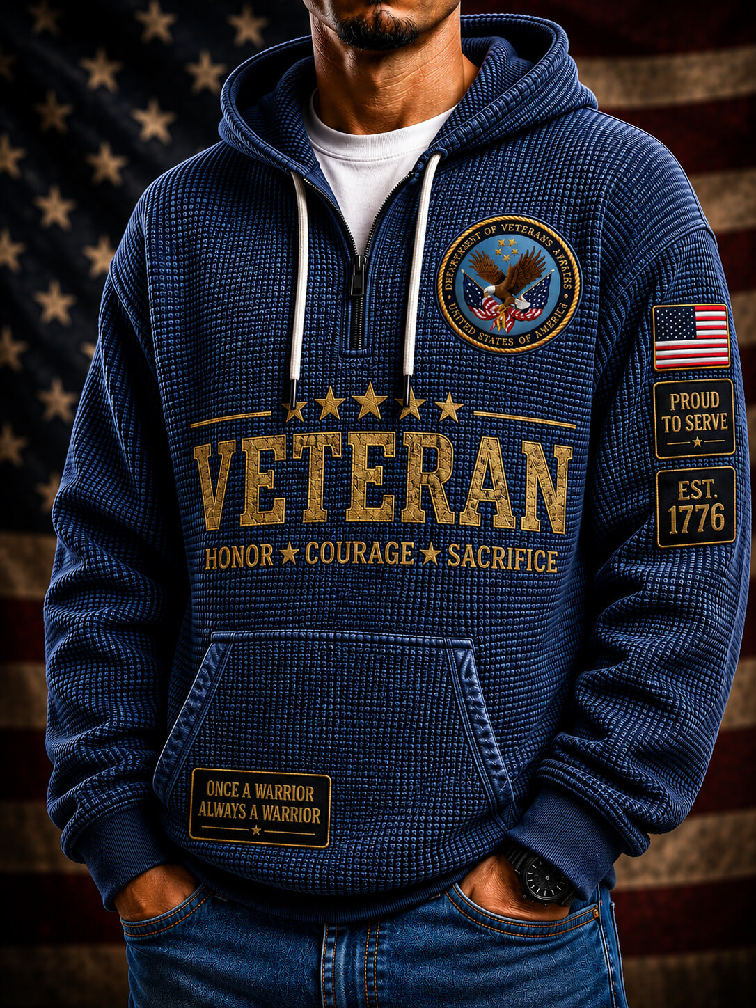 A blue pullover hoodie shown from both front and back, featuring large gold 'VETERAN' text, smaller white text, an eagle emblem, American flag patches, and drawstring hood. The hoodie is displayed against a dark patriotic background with spotlights and an American flag.