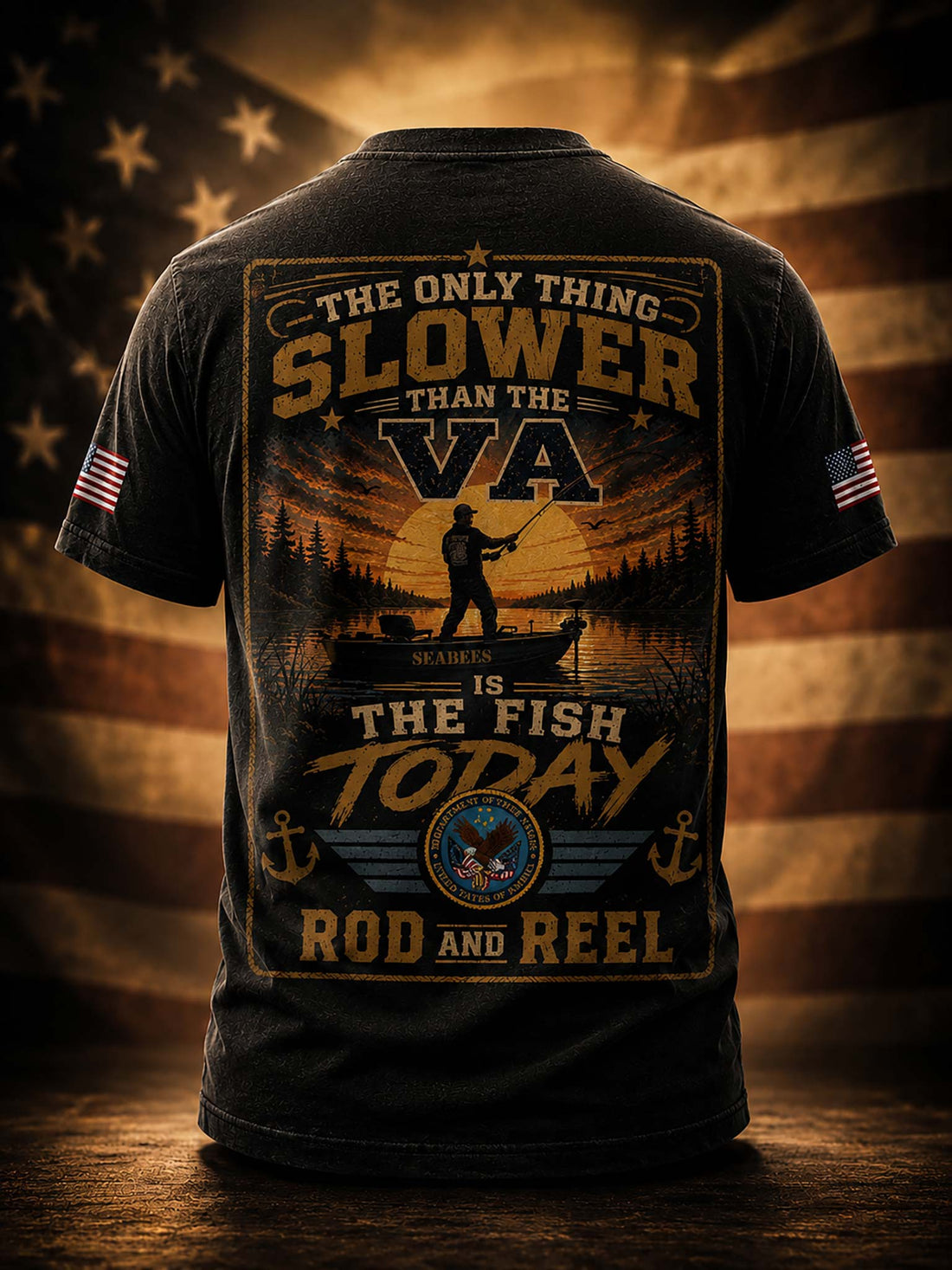 A black graphic t-shirt shown from the back, featuring a large fishing-themed print with the text 'THE ONLY THING SLOWER THAN THE VA IS THE FISH TODAY ROD AND REEL' and a sunset scene with a fisherman and boat. Small American flag graphics appear on both sleeves.