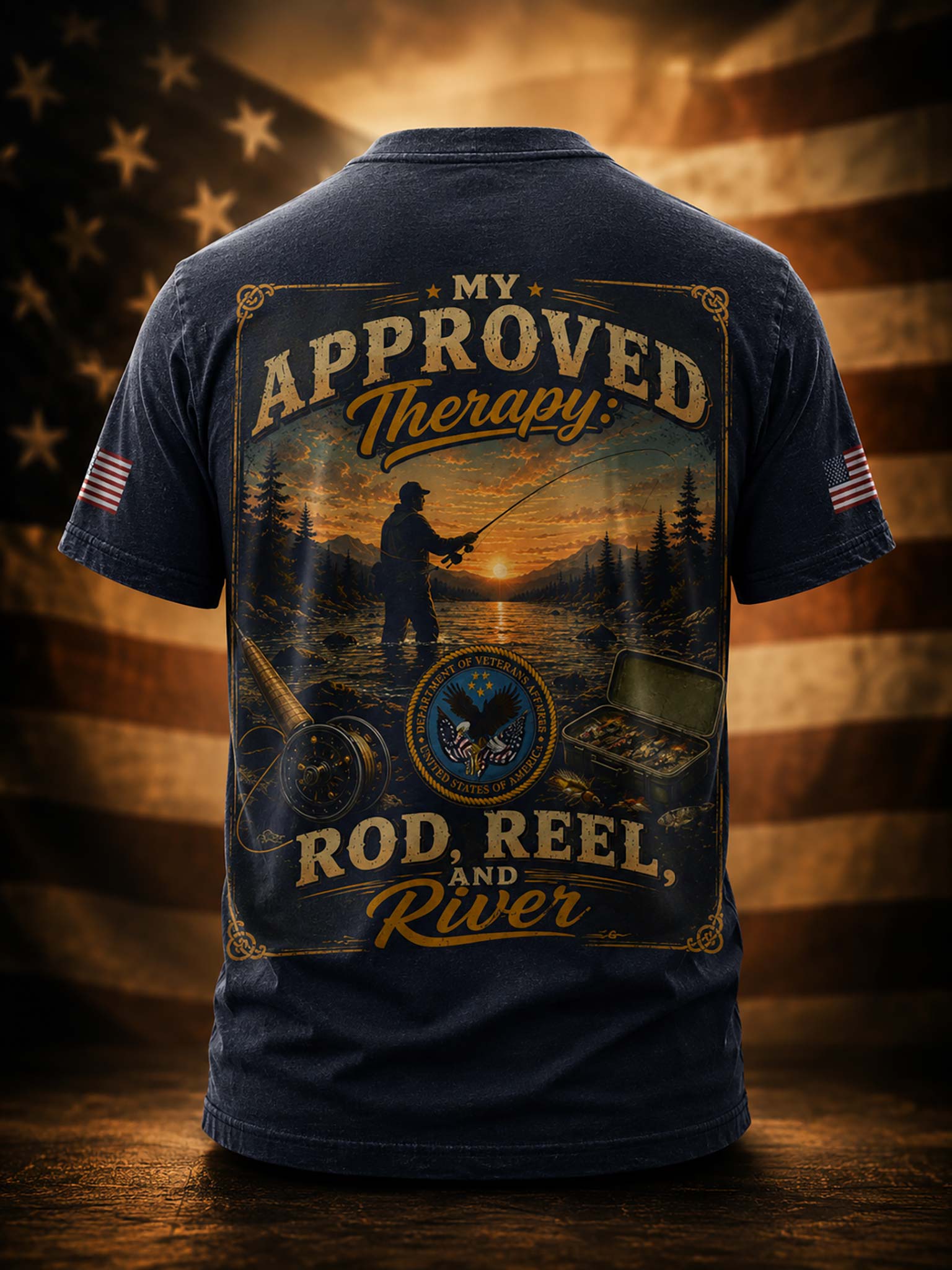 A navy blue short-sleeve t-shirt shown from the back, featuring a large fishing-themed graphic with the text 'My Approved Therapy: Rod, Reel, and River.' The design includes a silhouetted fisherman, a sunset over water, a fly fishing rod, a reel, and small fish.