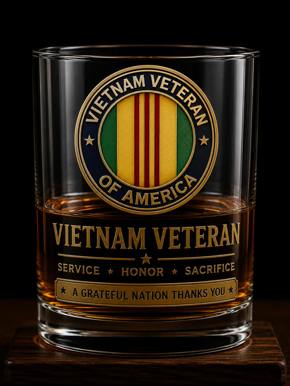 A clear whiskey tumbler with a Vietnam Veteran of America emblem and text printed on the front, filled with amber liquid and photographed against a black background.