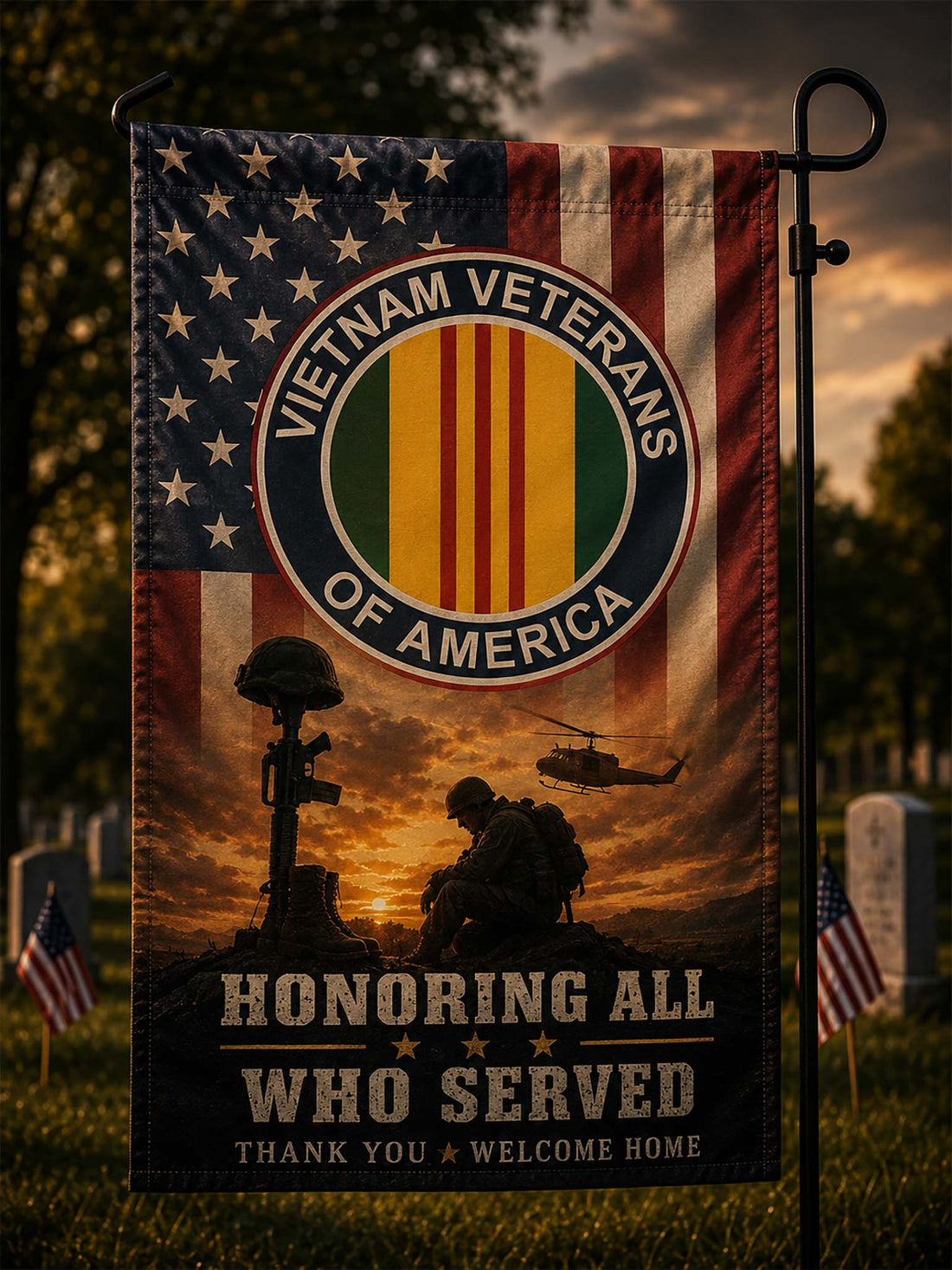 A vertical garden flag on a black metal stand, featuring the Vietnam Veterans of America emblem over an American flag and military memorial scene at sunset, with the text 'Honoring All Who Served' and 'Thank You Welcome Home.'.