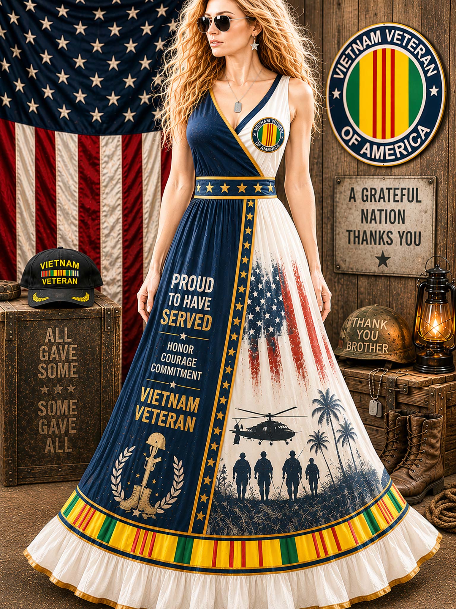 A woman modeling a patriotic Vietnam Veteran themed maxi dress in a rustic themed room with American flags, wooden crates, and military decorations. The dress features navy blue, white, and red graphics with text like 'PROUD TO HAVE SERVED' and 'VIETNAM VETERAN'.
